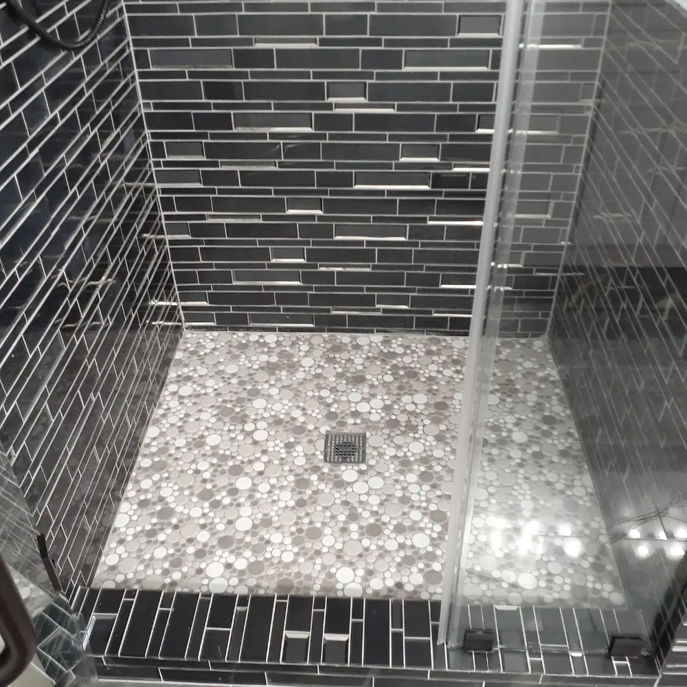 Close-up of shower floor with circular mosaic tiles