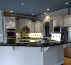 Modern kitchen with white cabinets and curved island