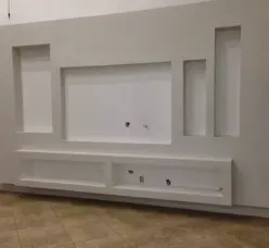 Custom-built white entertainment center with recessed areas