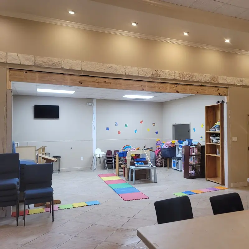 Newly renovated children's play area with colorful floor mats and toys